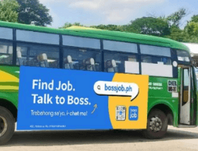 Closer side-angle crop of the Bossjob bus advertisement